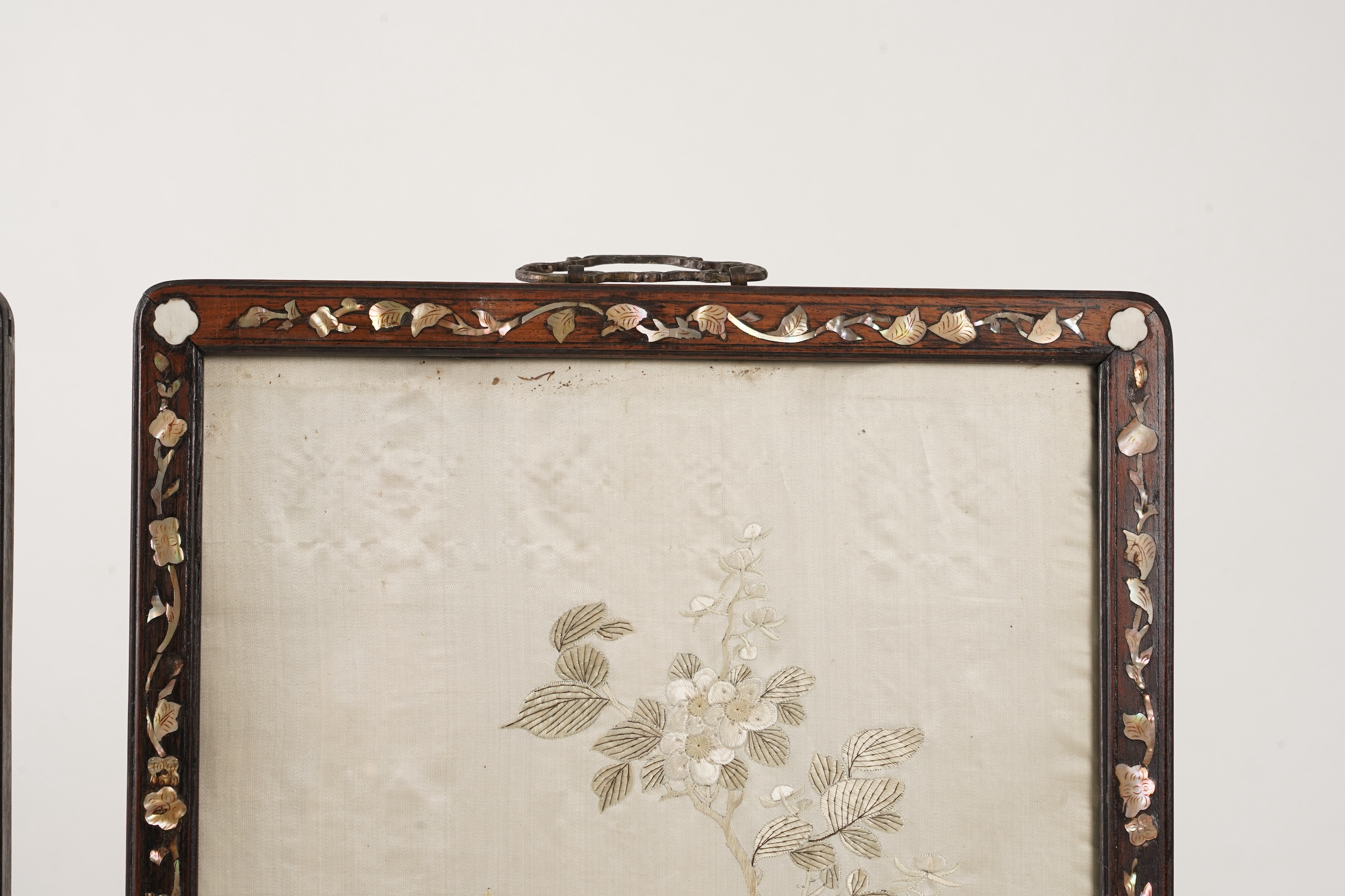 A pair of Chinese embroidered silk ‘bird’ panels, in mother-of-pearl inlaid hongmu frames, late 19th/early 20th century